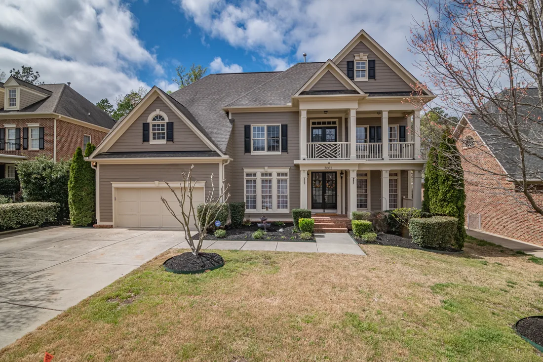 A house frontage with plain lawn and no planting before the work