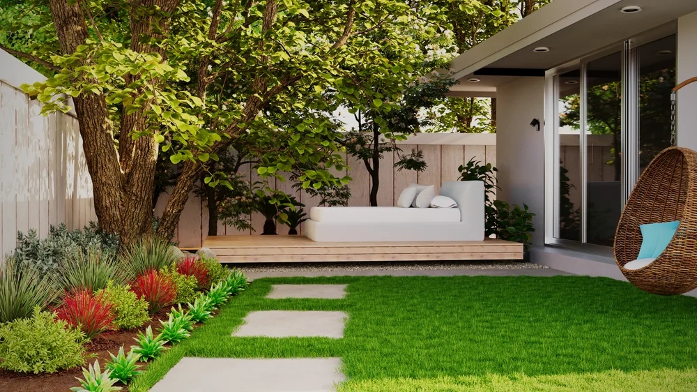 The same frontage with a paved path, beds and a shaped lawn